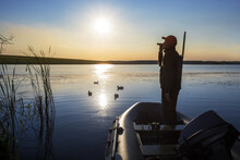 Hunter Calling Ducks At Lake. Duck Hunter.