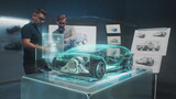 Fototapeta  - Two professional automotive engineers choose body of new eco-friendly electric car using futuristic augmented reality hologram. 3D computer graphics of vehicle high-tech developing. VFX animation.