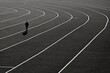 © Virginie Verglas - A person walking on a track in a captivating black and white scene