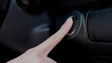 A Modern And Convenient Keyless Ignition System. Woman's Index Finger Press The Circular Button To Start The Engine.
