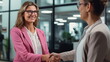 © mashimara - Young businesswoman shaking hands with a coworker