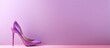 Studio shot of a purple background with a pink high heeled shoe for women isolated pastel background Copy space