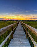 Fototapeta Na drzwi - wooden dock on the inlet at Pawleys Island in South Carolina in warm golden light at sunset
