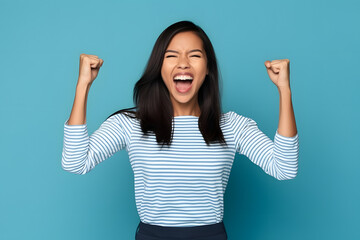 Sticker - Filipina young woman on blue studio cheering carefree and excited. Victory concept.