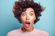 Portrait of shocked or surprised woman on pastel blue background