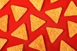 © Lightspruch - Pattern of Tortilla chips on a red background seen directly above.