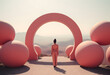 Woman in pink outfit standing in front of matching pink circle arch with hilltop view, art concept.