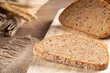 Slices of fresh rye bread with grains lie on the kitchen board,