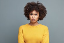 Disgusted Young African American Woman With Curly Afro Hair Wearing Yellow Sweater On Isolated Blue Background
