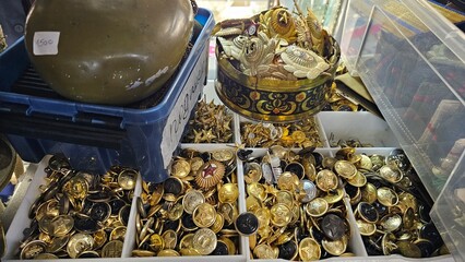 Buttons from military uniforms on the counter of an old things store.