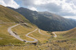 Camper van or motorhome on the Transfagarasan road among beautiful mountains in sunny weather. Serpentine road