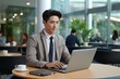© Banana Images - Asian handsome business man working on laptop at the coffee shop in the office, checking mail