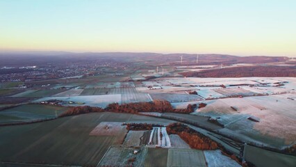 Wall Mural - drone footage from the german countryside fields with sunset sky on the horizon