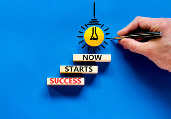 Wall Mural - Success starts now symbol. Concept word Success starts now on beautiful wooden block. Businessman hand. Beautiful blue table background. Business motivational success starts now concept. Copy space.