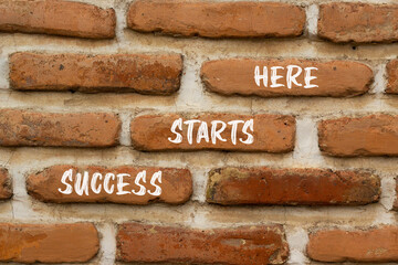 Wall Mural - Success starts here symbol. Concept word Success starts here on beautiful red brown bricks. Beautiful red brown brickwall background. Business motivational success starts here concept. Copy space.