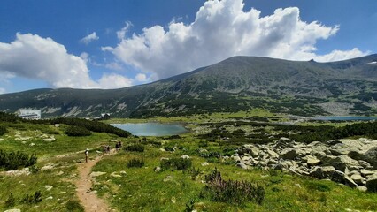 Poster - Scenic pathway leading to a tranquil lake surrounded by lush green grass: Bulgaria, Rila