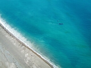 Sticker - Tranquil blue ocean lapping against a sandy beach