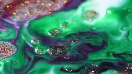 Sticker - Slow motion of glitter being filled into the green liquid