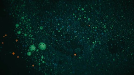 Sticker - Slow motion of green glitter floating on the surface of a liquid