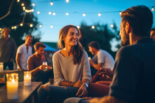 Group of friends laughing and enjoying drinks at outdoor bar during summer evening