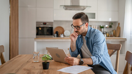 Wall Mural - one man adult caucasian work on laptop at home happy smile