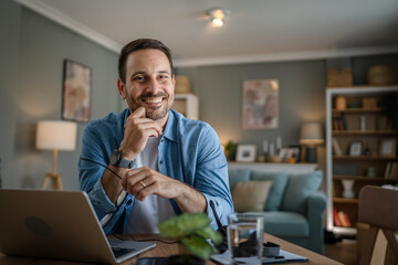 Wall Mural - one man adult caucasian work on laptop at home happy smile