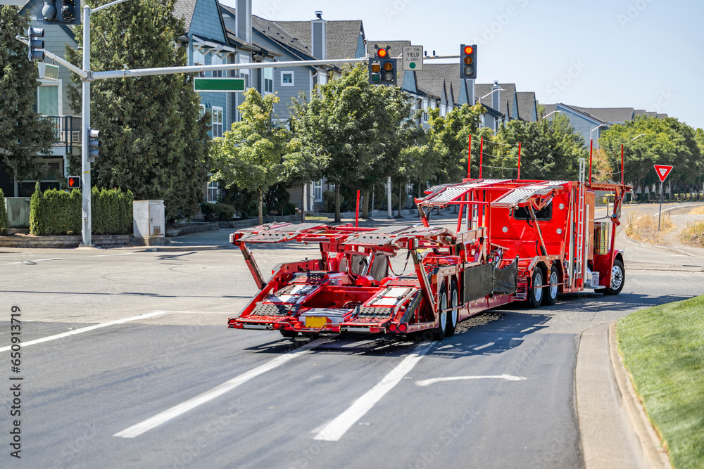 Bright red big rig classic car hauler semi truck with empty hydraulic ...