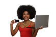 © Edson Souza - a woman with a laptop holds a black credit card and smiles enthusiastically,