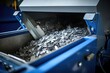 A closeup of an advanced shredder machine, specifically designed to break down various types of waste materials into smaller, manageable pieces before further processing.