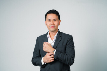 Asian businessman in suit with looking at camera standing studio isolated on gray background, young asian business man is manager or executive smiling and having confident is positive with success.