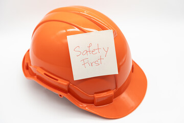 Orange safety hat with message Safety First. hard hat isolated on white background.