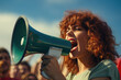 Woman passionately shouting into green megaphone. This image can be used to depict activism, protests, or public speaking engagements.