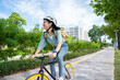 Portrait of smiling asian woman lifestyle using bike in summer travel means of transportation, ECO friendly