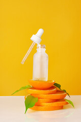 Wall Mural - Skincare oil bottle on stacked orange slices