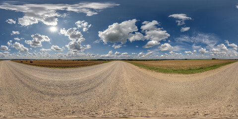 Wall Mural - 360 hdri panorama on gravel road with marks from car or tractor tires with clouds on blue sky in equ