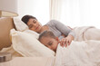 © IndiaPix - Mother and daughter sleeping together in bed