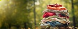 Fototapeta  - Large stack of various cotton clothes for recycling or charity. Banner, place for text