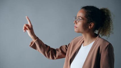 Poster - Young black woman touching holographic images. Virtual reality.