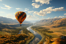 Red Orange Hot Air Balloon Flies Against A Partly Cloudy Sky Above A River Through A Beautiful Valley With A Backdrop Of Mountains