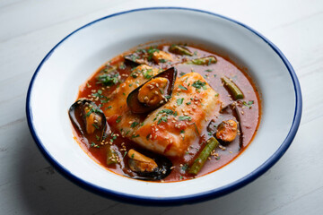 Wall Mural - Hake with tomato sauce and mussels. Traditional recipe from northern Spain.