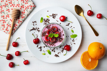 Wall Mural - Cherry panna cotta served in a glass with fresh fruit and grated chocolate.