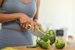 © Prathankarnpap - Young woman cutting fresh broccoli on chopping board, preparing healthy meal in kitchen