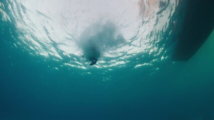 Poster - Underwater view of a woman jumping into the water from the boat