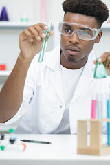 male student of chemistry working in laboratory