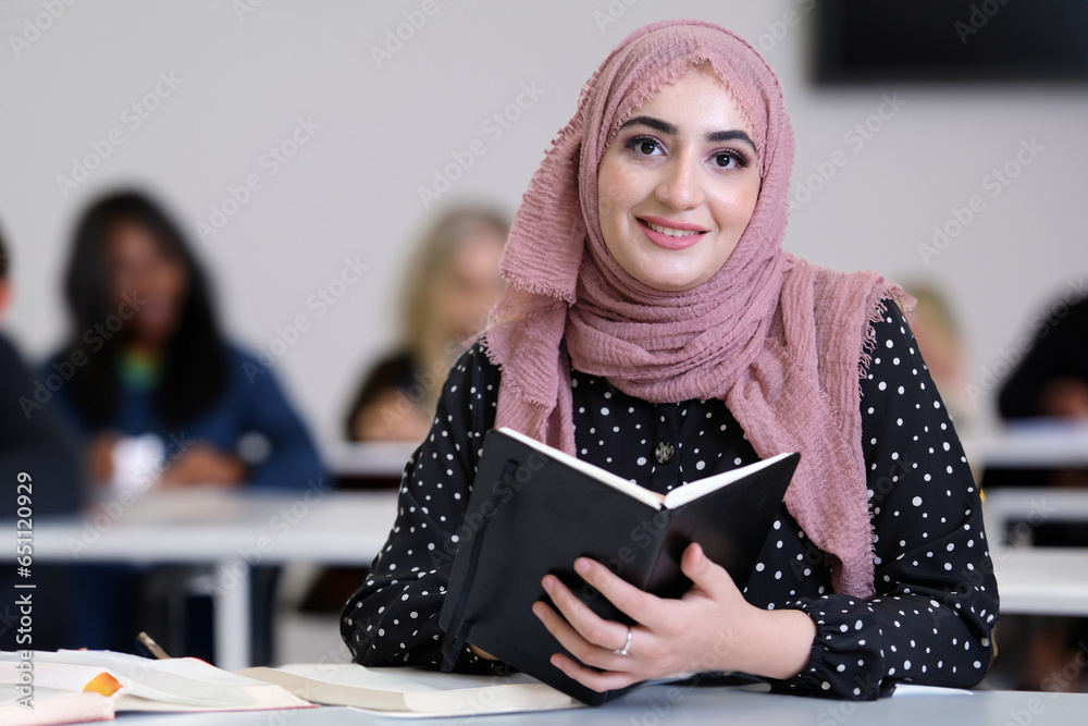 Arabic Student Beautiful Emirati Arab student at university campus classroom with ...