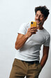 © SHOTPRIME STUDIO - Lifestyle man white casual message online t-shirt hipster confident portrait technology phone