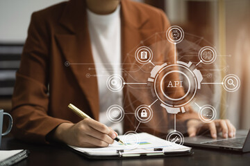 Modern technology and networking concept, woman using laptop, tablet and smartphone with virtual screen API icon Software development tool. API Application Programming Interface.