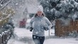 © mariyana_117 - close-up a young woman jogging on a snowy mountain trail, with a backdrop of snow-capped peaks