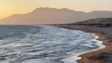 Patara Beach, Natural Sunset Over Sand Dunes And Desert View Beach. Mediterranean Sea Waves On White Beach With Mountain Ridges. Vacation Concept. Amazing Nature Landscape Of Turkish Riviera In Turkey