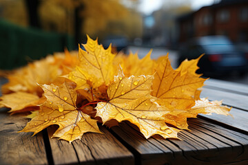 Wall Mural - Yellow maple leaves on a wooden table with a blurred bokeh background. Empty free space for product display